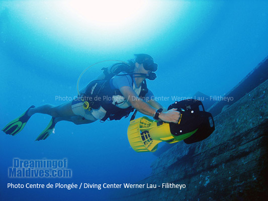 Diving on one of Filitheyo's Wreck with a scooter . Faafu Atoll