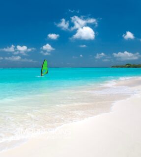 Windsurfing across turquoise lagoon in the Maldives....  📷 @impressionsphotobysakis  #luxurytravel #luxurylifestyle #beachlife #indianocean #windsurfing