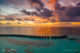 Aerial view at sunset of OZEN Life Maadhoo water villas