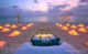 romantic sunset beach dinner at a table dug in the sand at Dusit Thani Maldives