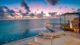 Baros Maldives water villa at sunset