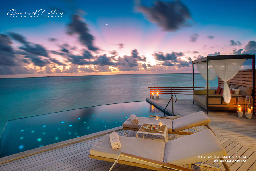 Baros Maldives water villa at sunset
