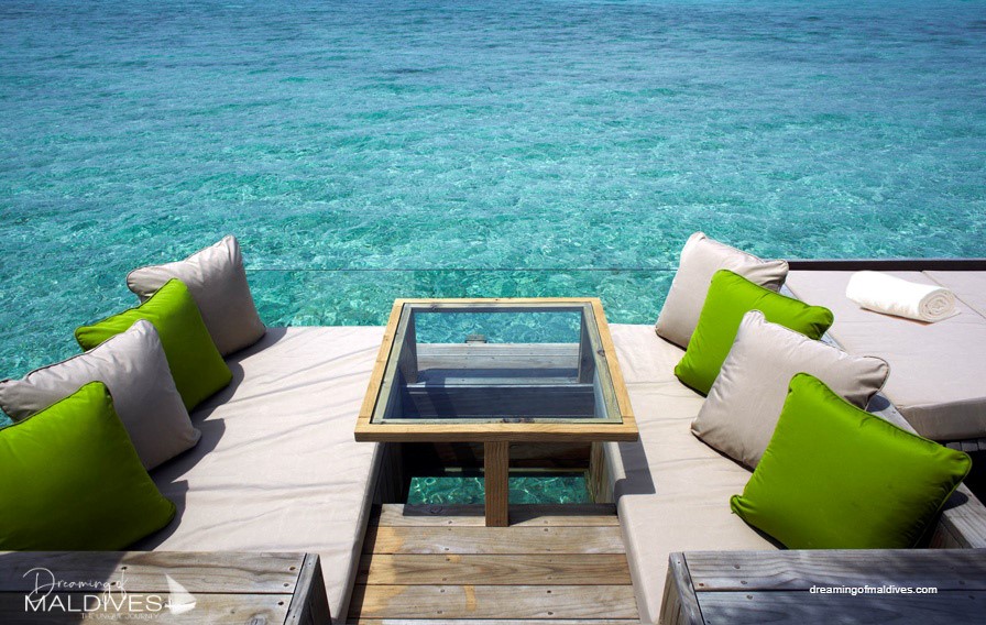 Six Senses Laamu water villa Aquarium dining deck with all-glass table