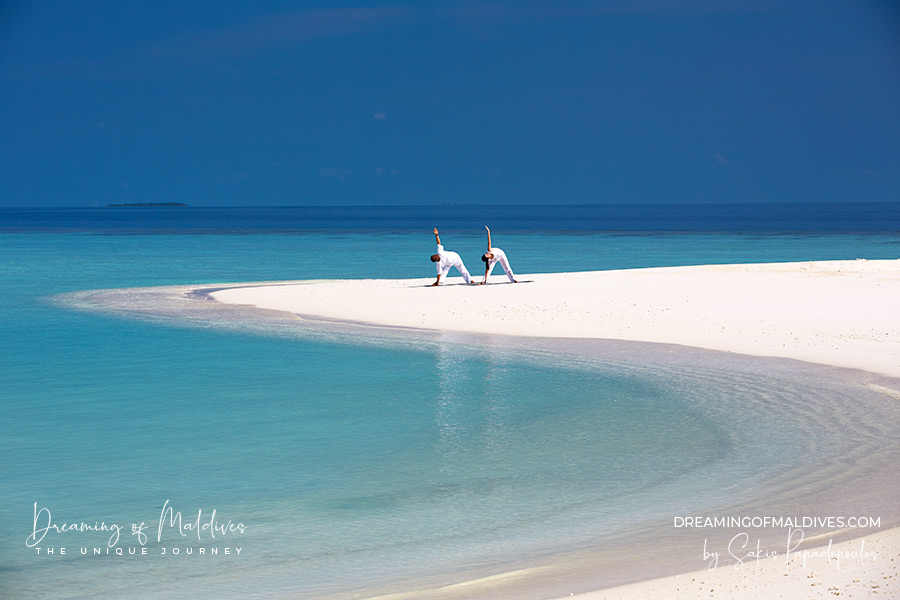 Yoga on the beach at Anantara Kihavah Maldives